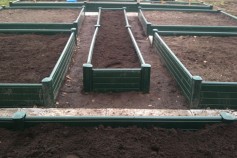 Classic Green Gravel boards used as veg planters.